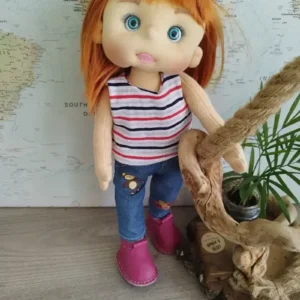 Mu&ntilde;eca artesanal de trapo con estilo moderno, vestida con pantal&oacute;n vaquero, camiseta y zapatos de piel rosa.